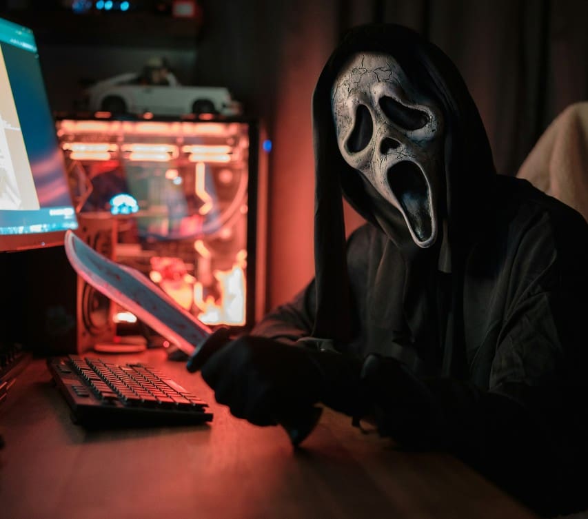 Ghostface in front of a computer
